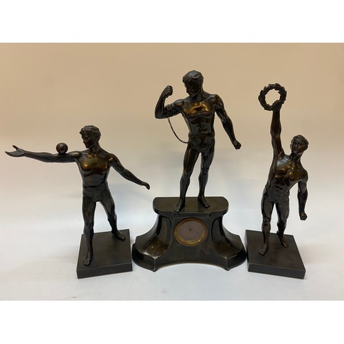 217 - A clock in a spelter case with a surmount of a male figure in chains - 14in high. together with two ... 