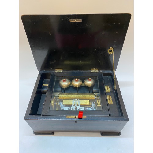 223 - A musical box playing on three bells in a rosewood, satinwood and ebonised case, on bracket feet - 1... 