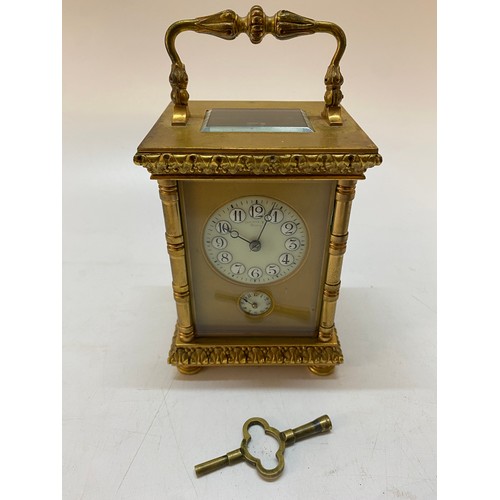 214 - A Victorian carriage clock, gilt face, circular enamel dial, alarm dial, striking movement on a gong... 