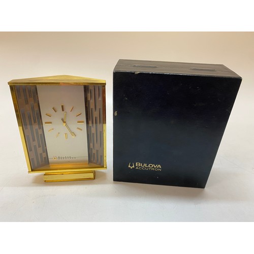 215 - A Bulova Accutron clock in a brass case - 7in. high, in original box