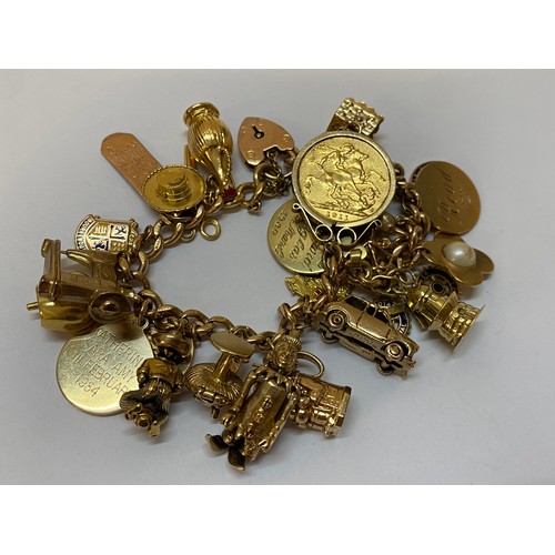 179 - A 9ct. gold bracelet with heart shaped padlock hung with many 9ct. gold charms including a motor car... 