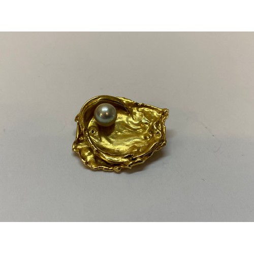 182 - A gold coloured metal nugget form brooch set pearl
