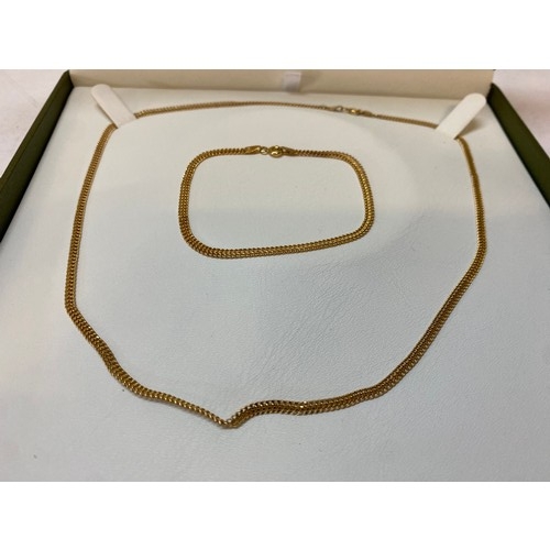 187 - A 9ct. gold necklace and matching bracelet, in fitted box