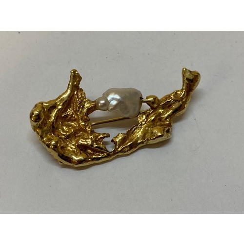 184 - A gold coloured metal nugget form brooch set blister pearl