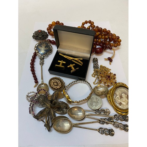 199 - A row of graduated cherry bakelite amber beads, a Niello work brooch, a set of six Continental silve... 