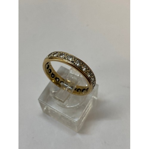 193 - An eternity ring set white stones, on a 9ct. gold shank