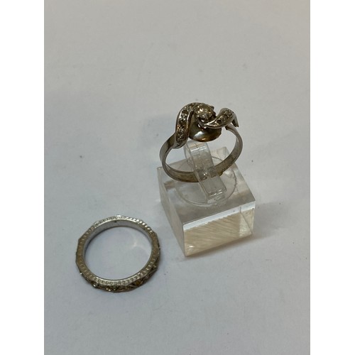 198 - A lady's ring of crossover design set centre diamond with old cut diamond set shoulders, on a white ... 