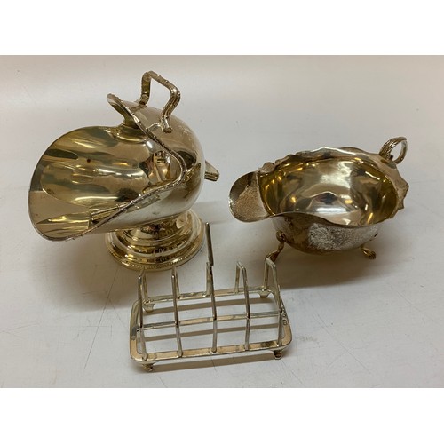 161 - A small silver four division toastrack, a silver sauce boat with serrated rim and a silver plated su... 