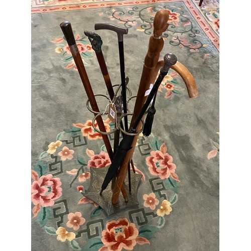 212 - A selection of walking sticks including two with silver collars, parasol with silver handle and a br... 