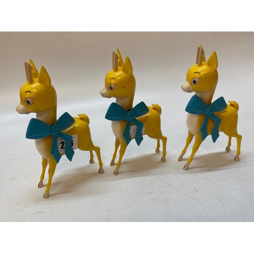 216 - A set of three 1950's plastic Babycham advertising models with ribbons - 7 1/2in. high
