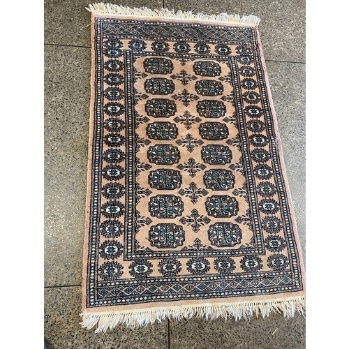 1 - A Bokhara rug, pink field with repeating decoration - 48in. x 32in., a large Bokhara rug, pink field... 