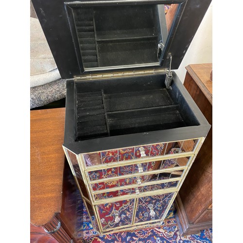 79 - A millinery cupboard fitted hinged lid enclosing jewellery compartment above four drawers and two do... 