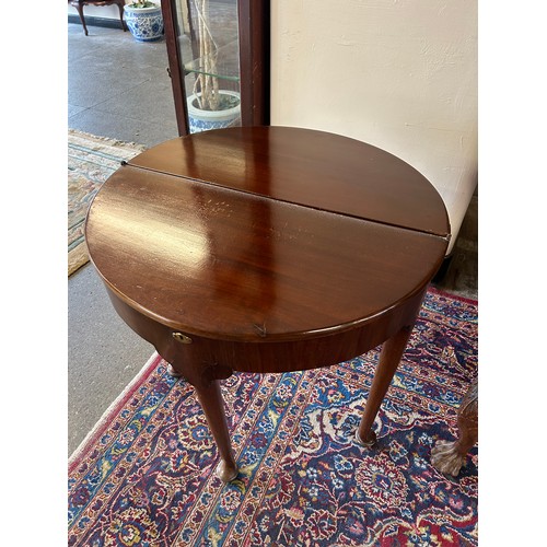 54 - A George II mahogany tea table with half round folding top, on slender legs with pad feet - 27 1/2in... 