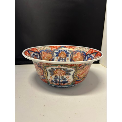 102 - A Japanese Arita bowl decorated in Imari colours with cranes and flowers in alternate panels, four c... 