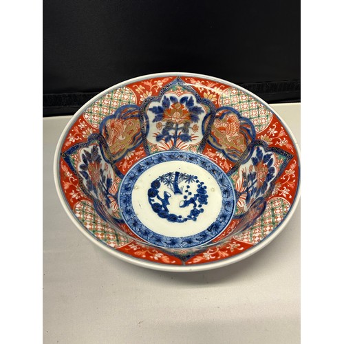 102 - A Japanese Arita bowl decorated in Imari colours with cranes and flowers in alternate panels, four c... 