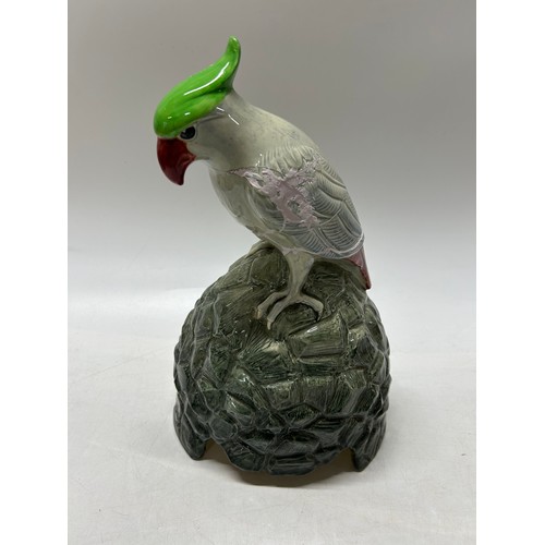 94 - A Royal Doulton speaker cover in the form of a cockatoo on a rocky base, designed by Charles Noke, m... 
