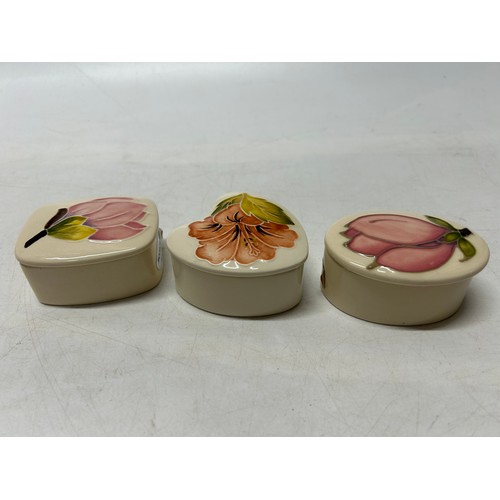 123 - Three small Moorcroft trinket boxes, cream ground decorated magnolia and hibiscus