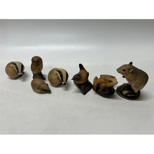 131 - Six Purbeck Pottery models comprising:- gerbil, badger (2), owl, frog and hedgehog and one other sim... 