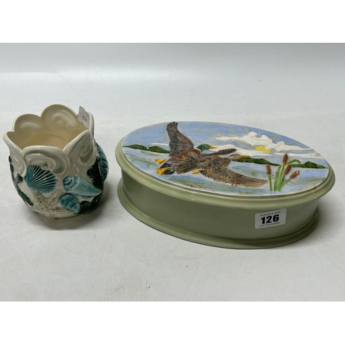 126 - A large oval trinket box, the lid decorated mallards - 9in. wide and a vase decorated seashells in b... 