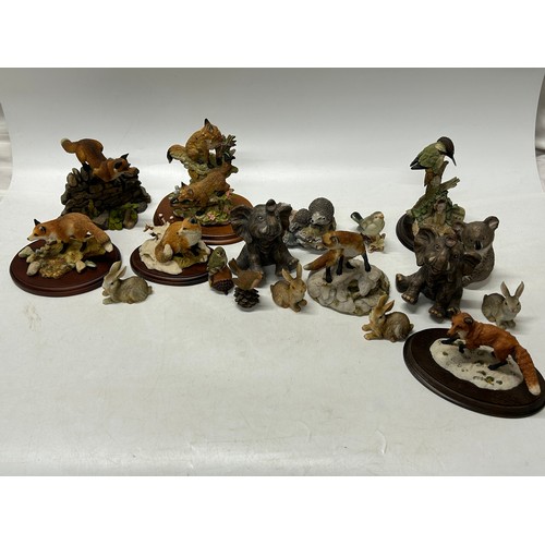 127 - A collection of Teviotdale, Royal Doulton and other resin models of animals including foxes, cows, b... 