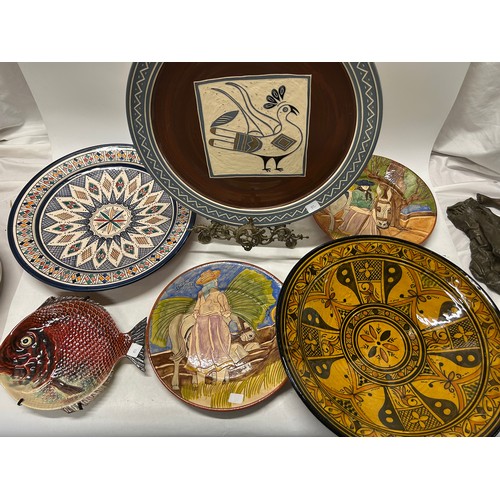 82 - Two Continental terracotta plates decorated peasants - 12in. dia., a Continental terracotta bowl, ye... 