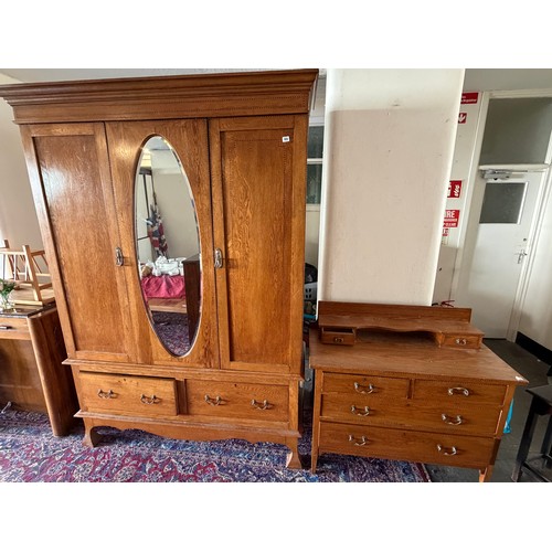 50 - An Edwardian oak wardrobe with ebony and satinwood inlay fitted centre mirrored door flanked to each... 