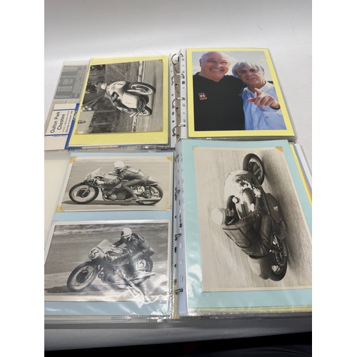 22 - A folder of coloured and black and white photographs bearing signatures comprising:- Geoff Duke, Mik... 
