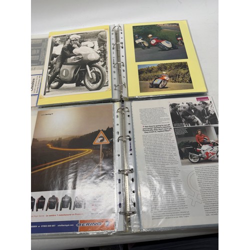 22 - A folder of coloured and black and white photographs bearing signatures comprising:- Geoff Duke, Mik... 