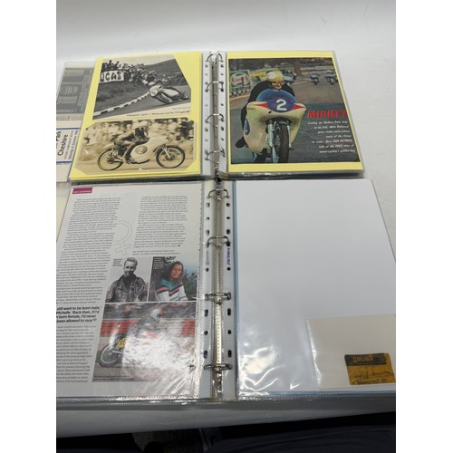 22 - A folder of coloured and black and white photographs bearing signatures comprising:- Geoff Duke, Mik... 