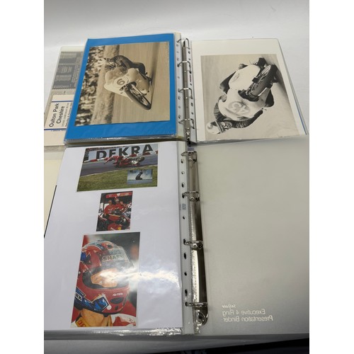 22 - A folder of coloured and black and white photographs bearing signatures comprising:- Geoff Duke, Mik... 