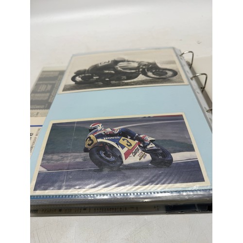22 - A folder of coloured and black and white photographs bearing signatures comprising:- Geoff Duke, Mik... 