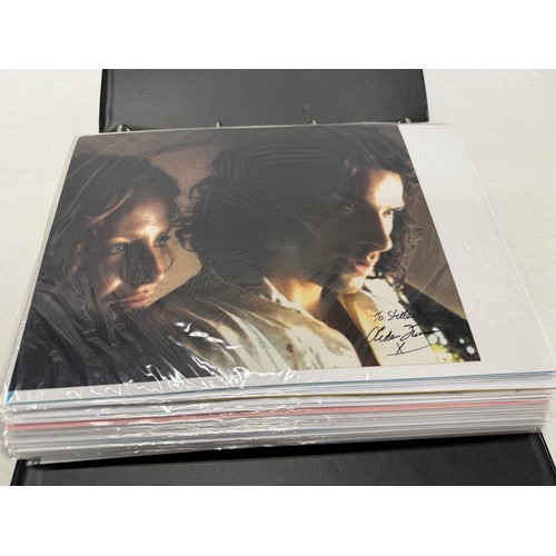 23 - A folder of coloured and black and white photographs bearing signatures comprising:- Aiden Turner, J... 