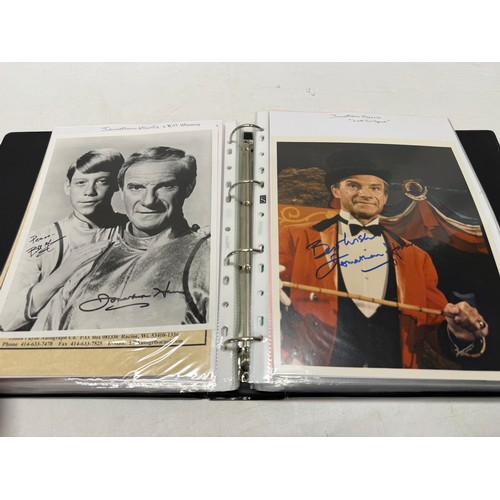 23 - A folder of coloured and black and white photographs bearing signatures comprising:- Aiden Turner, J... 