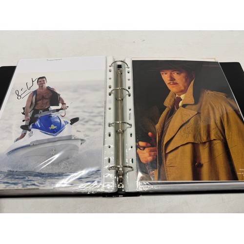 23 - A folder of coloured and black and white photographs bearing signatures comprising:- Aiden Turner, J... 