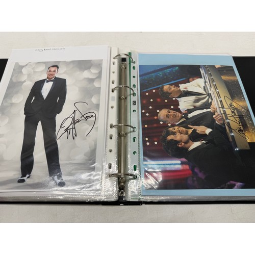 23 - A folder of coloured and black and white photographs bearing signatures comprising:- Aiden Turner, J... 