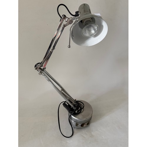 46 - A chrome spotlight on a piston base