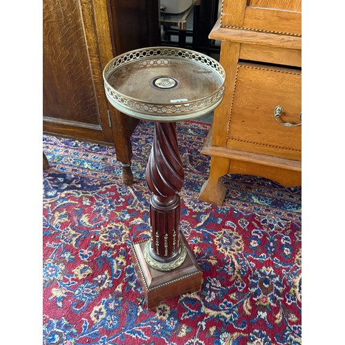 57 - A torchere with circular galleried top, wrythen column, on square base with gilt metal mounts