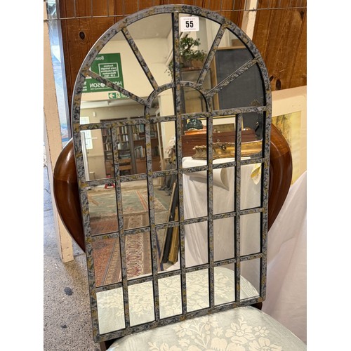 55 - An arched wall mirror in a sectional frame