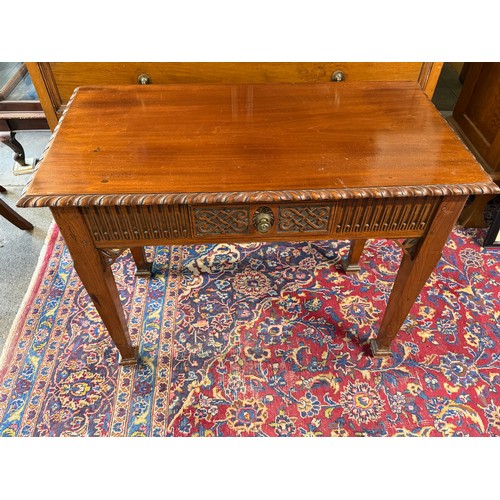 66 - A mahogany side table with rectangular top, fret carved frieze fitted centre drawer, on square legs ... 
