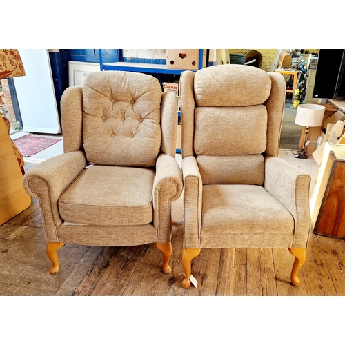 321 - Two upholstered armchairs on cabriole legs