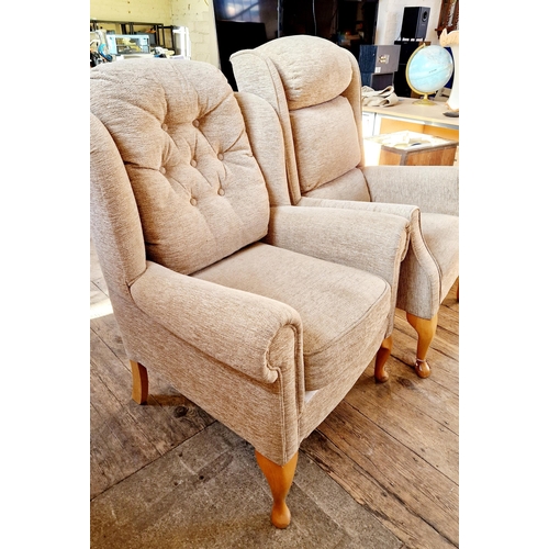 321 - Two upholstered armchairs on cabriole legs