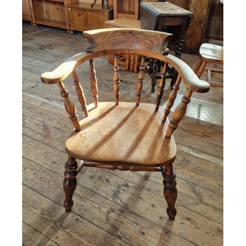 Early 20th century oak spindle back tub chair on turned supports