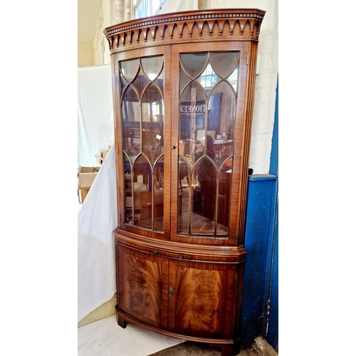 348 - Reproduction mahogany corner cabinet with Gothic arch fretted glazed upper section over a slide and ... 