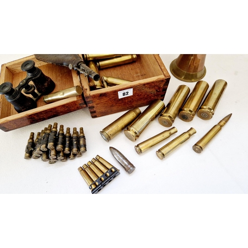 82 - Collection of brass and other militaria comprising a quantity of shell and bullet cases; gun oiler; ... 