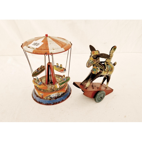 160 - Two vintage tin plate clockwork toys, carousel and riding figure, British made