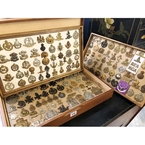 216 - Collection of c.150 British regimental and military cap and other badges in a wooden cabinet