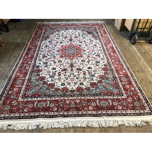 249 - Large modern Persian green and red floral patterned woollen rug, approx. 118