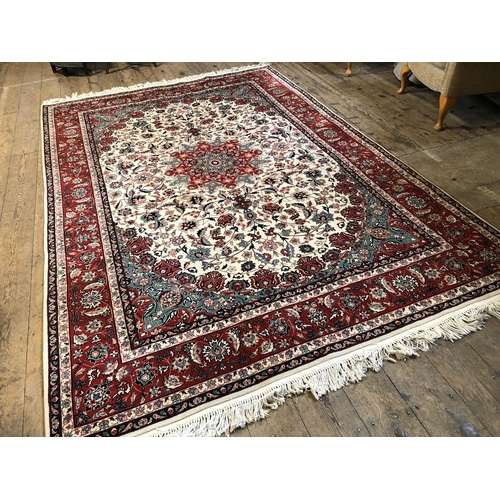 249 - Large modern Persian green and red floral patterned woollen rug, approx. 118