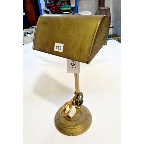 250 - Early 20th century heavy brass desk lamp with shade, on circular desk tidy, indented, pedestal base