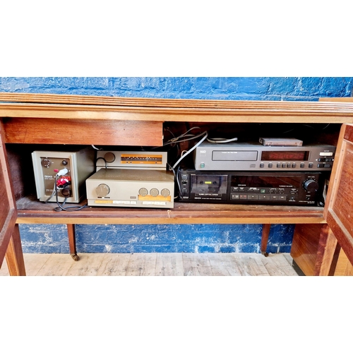 257 - Qty of hifi equipment in a converted washstand cabinet incl. NAD 5440 CD player, Quad 303 amp, tuner... 